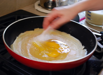 Whisking the egg on the crepe