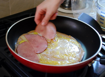 Layering ham on crepes