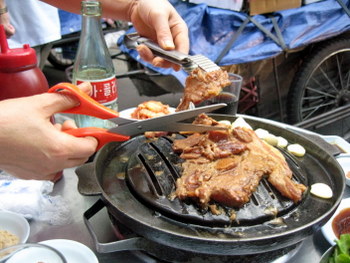 Korean BBQ Pork being cut